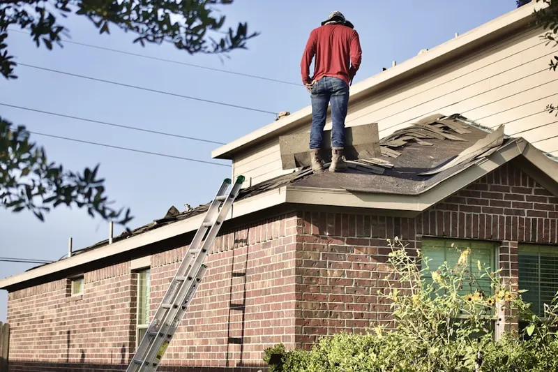 Professional roofer working on a residential roof in Upper Clinton Hill